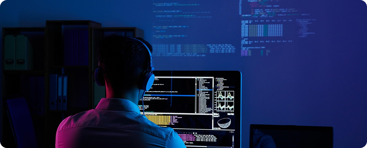 Developer coding in a dark room visual context
